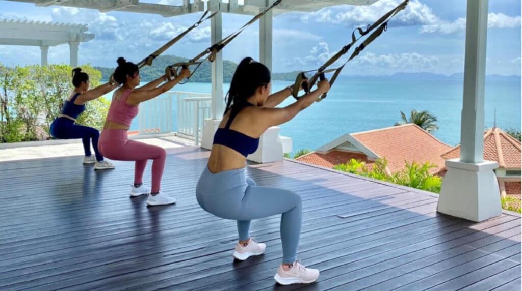 A serene yoga session at CT-Wellness, featuring a peaceful outdoor setting with participants practicing asanas under the guidance of a certified instructor.